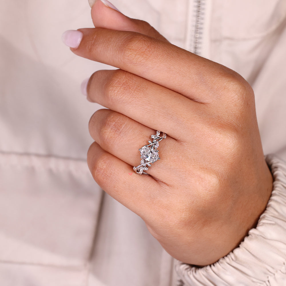 Oval cut diamond ring featuring hand engraved filigree details.
