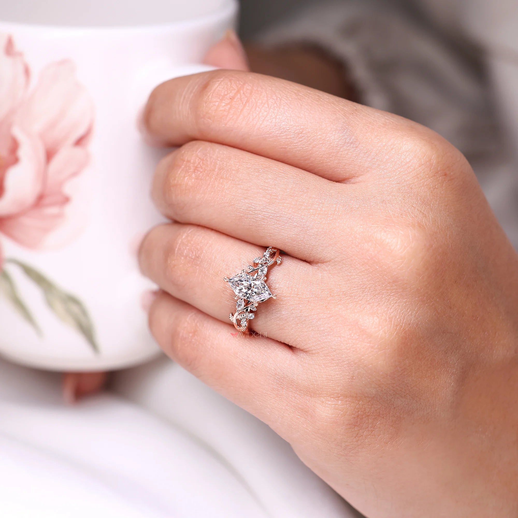 Marquise and round side stone with leaf style prong.