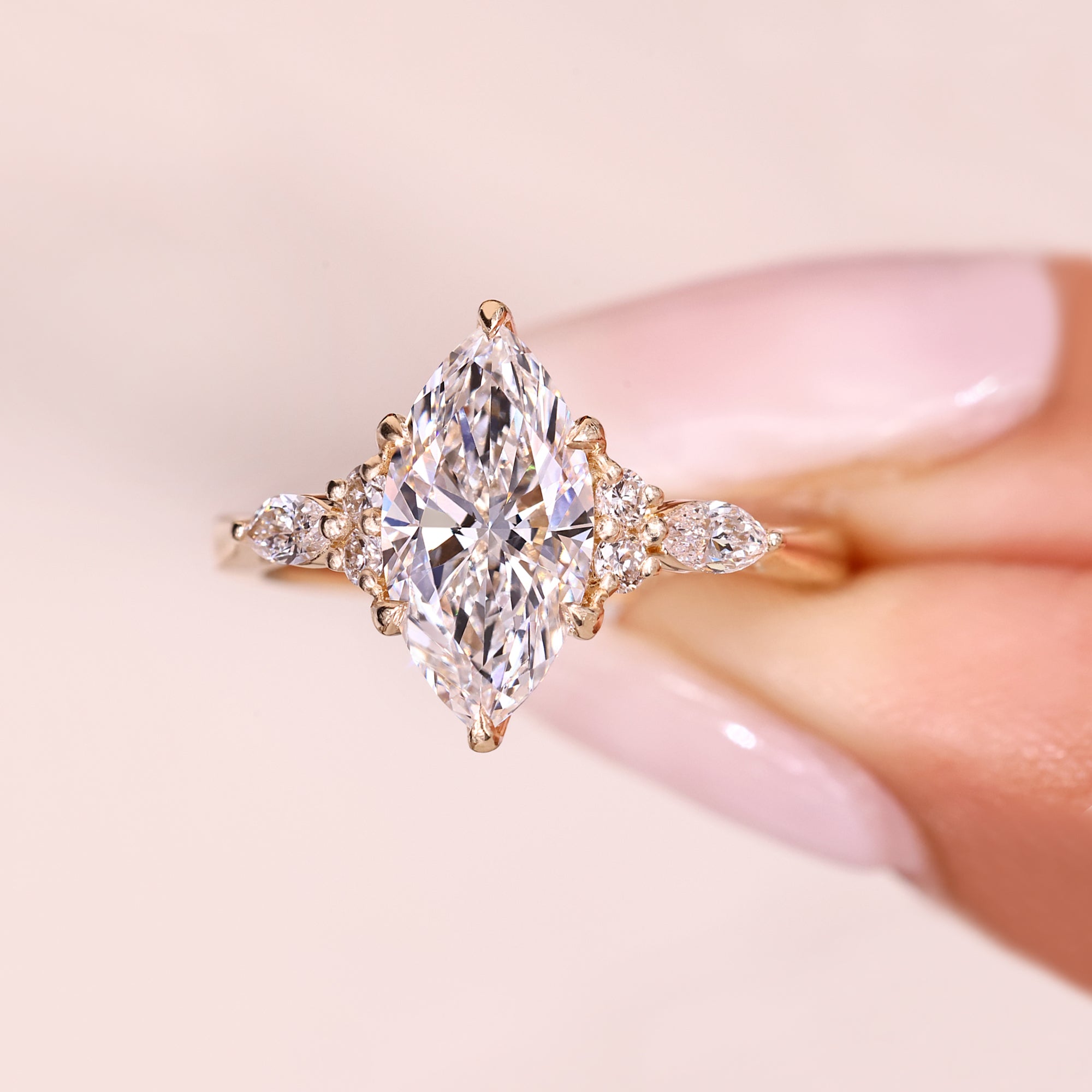 Marquise diamond ring with tapered shank detail.
