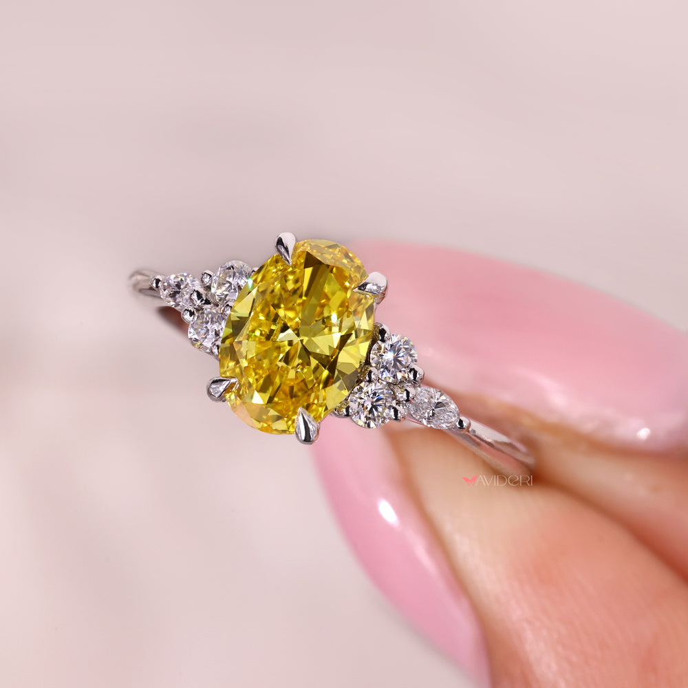 Oval yellow diamond ring with refined side stone design.