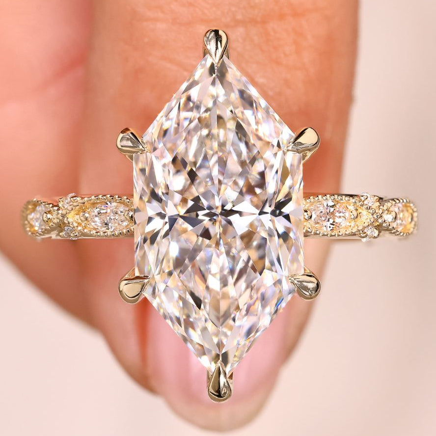 Dutch marquise diamond ring with round side stones.
