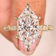 Dutch marquise diamond ring with round side stones.
