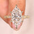 Dutch marquise diamond ring with round side stones.
