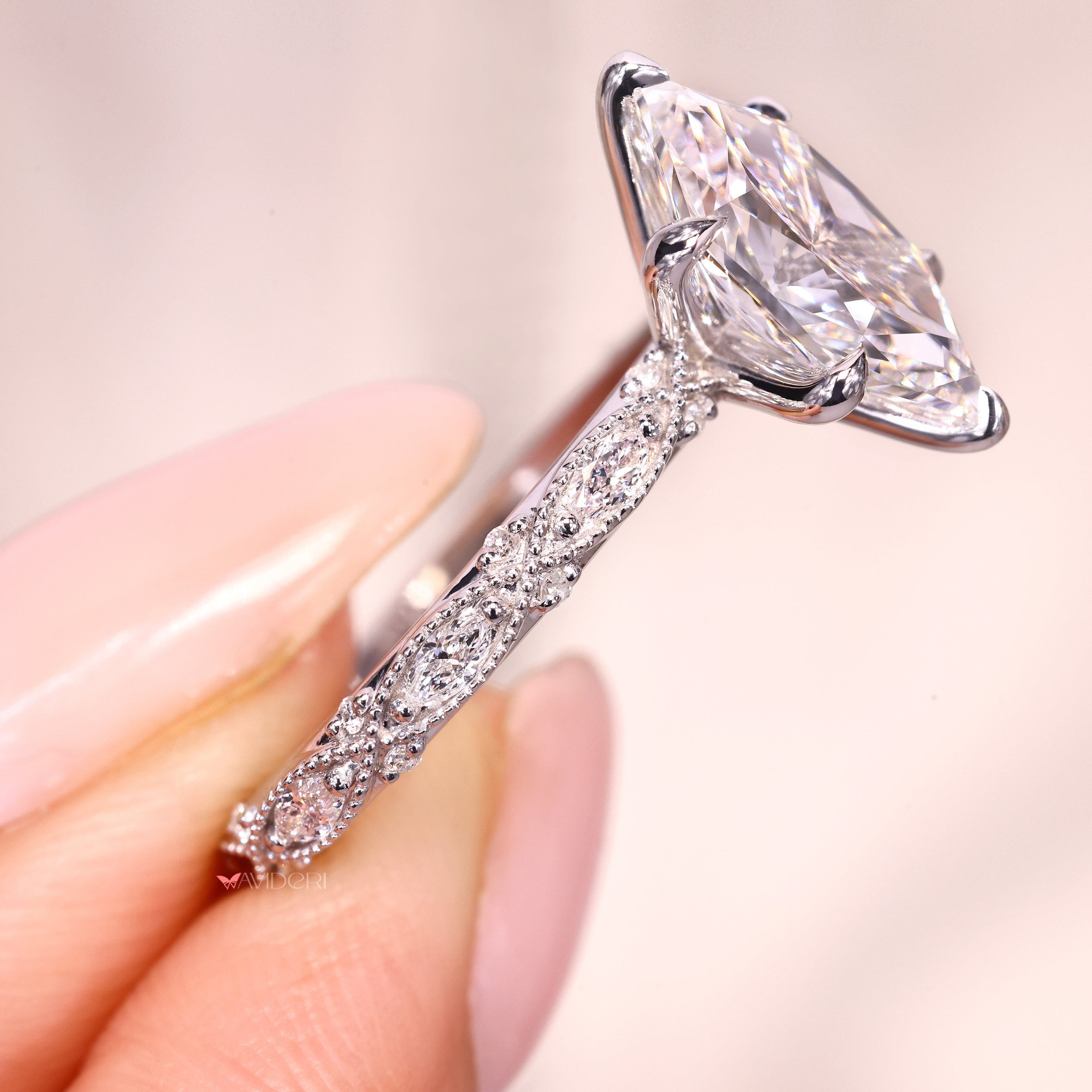 Marquise diamond ring with vintage band and side stones.
