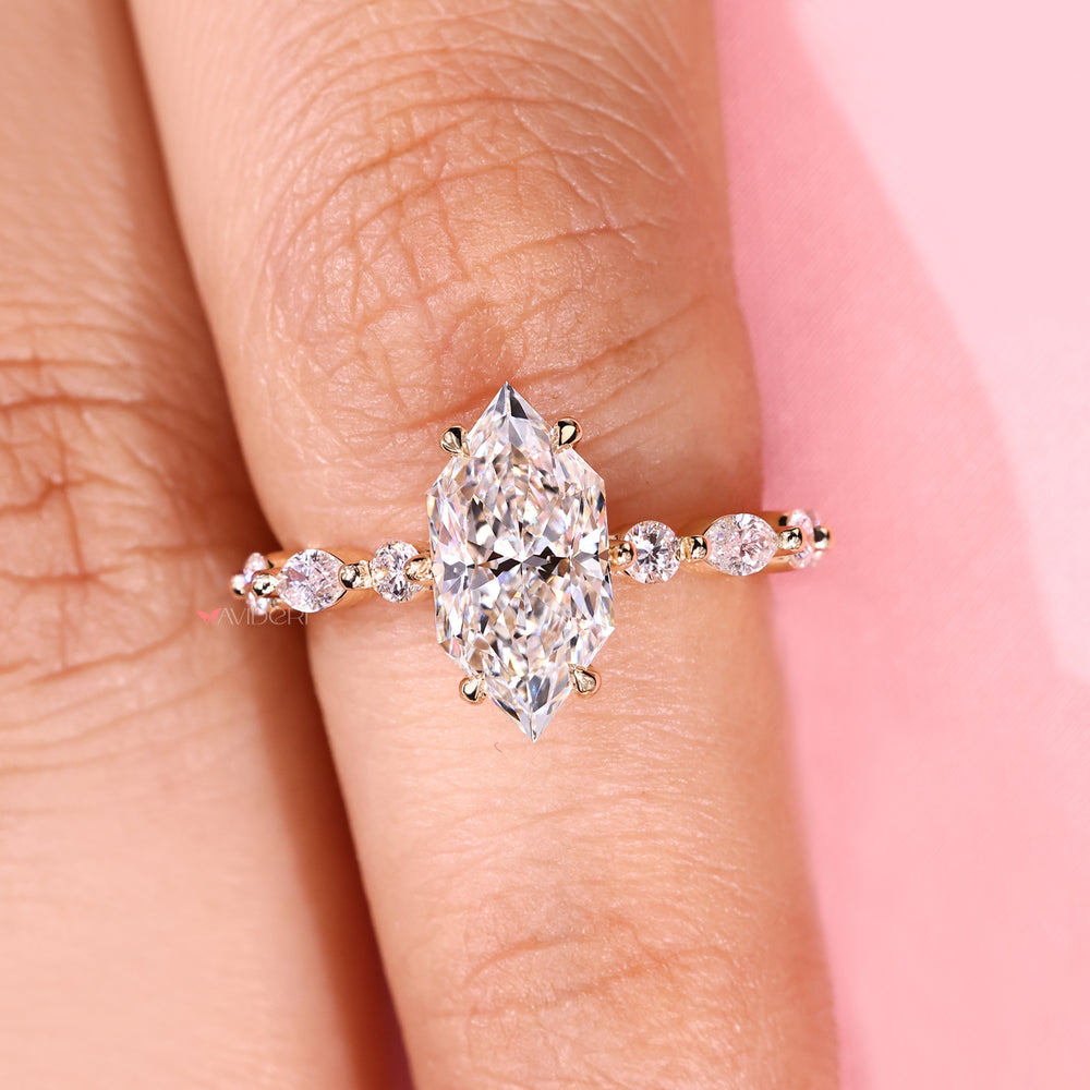 Dutch marquise diamond ring with round side stones.
