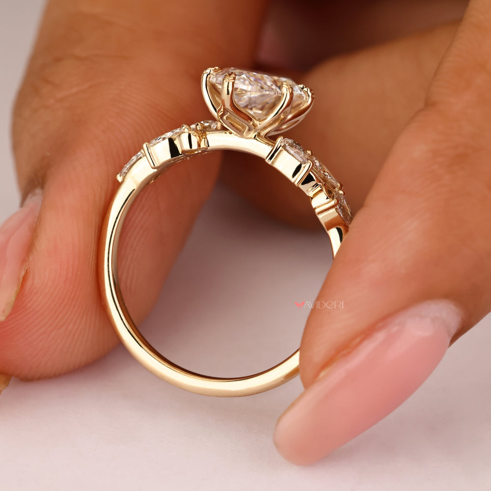 Nature inspired ring with marquise center and pear side stones
