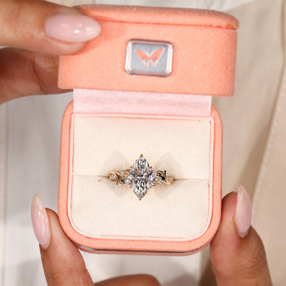 Nature inspired marquise diamond ring with leaf style prongs
