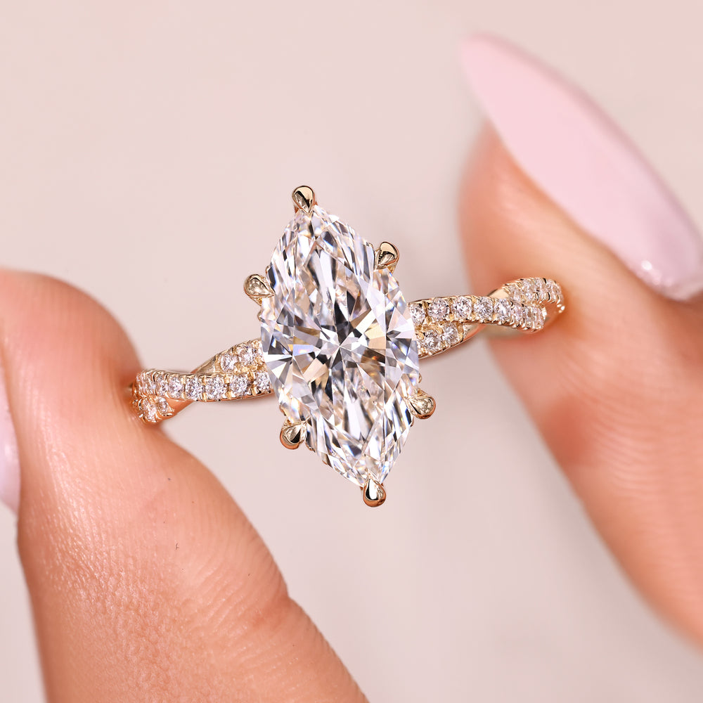 Marquise cut diamond ring with round diamond halo accents.

