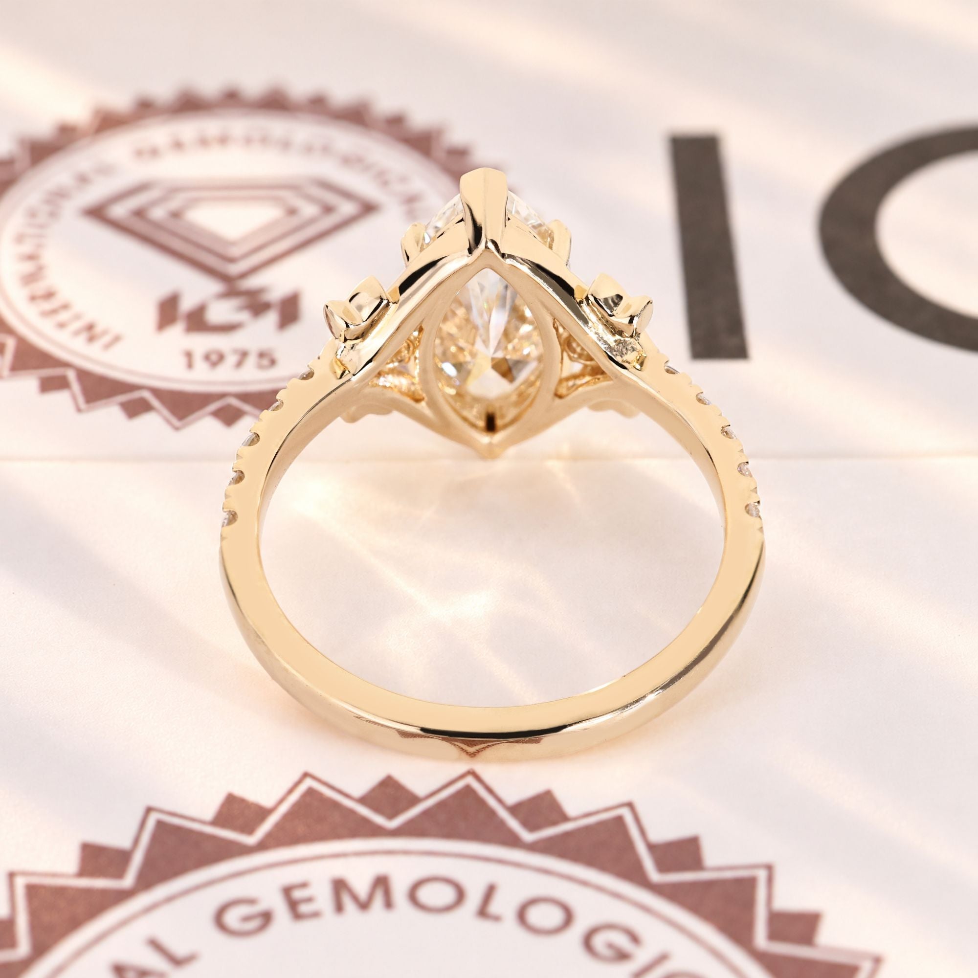 Marquise diamond ring with round diamond pave style.
