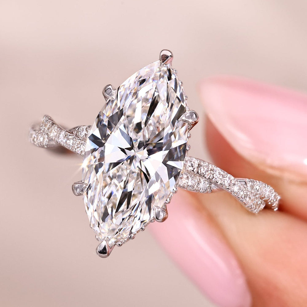 Marquise cut engagement ring with twisted pave setting.