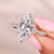 Marquise cut engagement ring with twisted pave setting.
