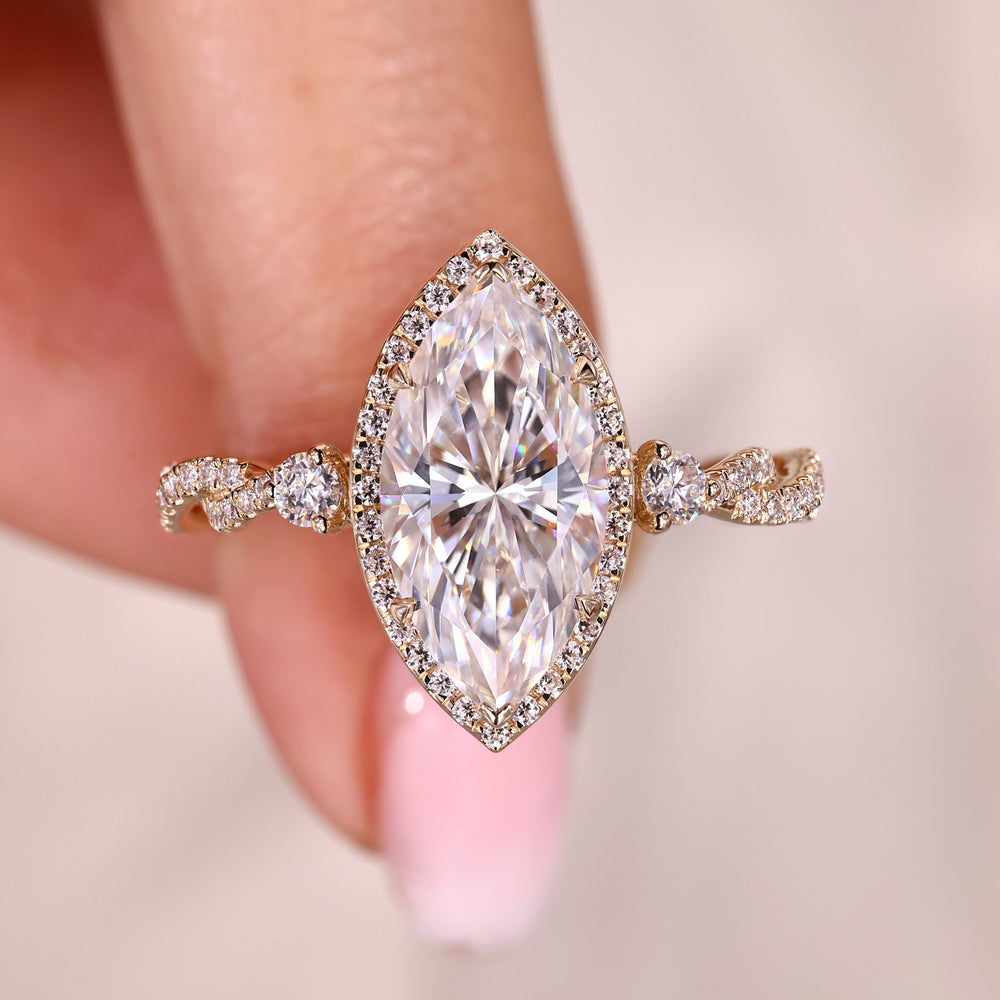 Halo marquise moissanite engagement ring with v prongs.