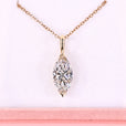 Diamond necklace with rose gold chain on a pink background