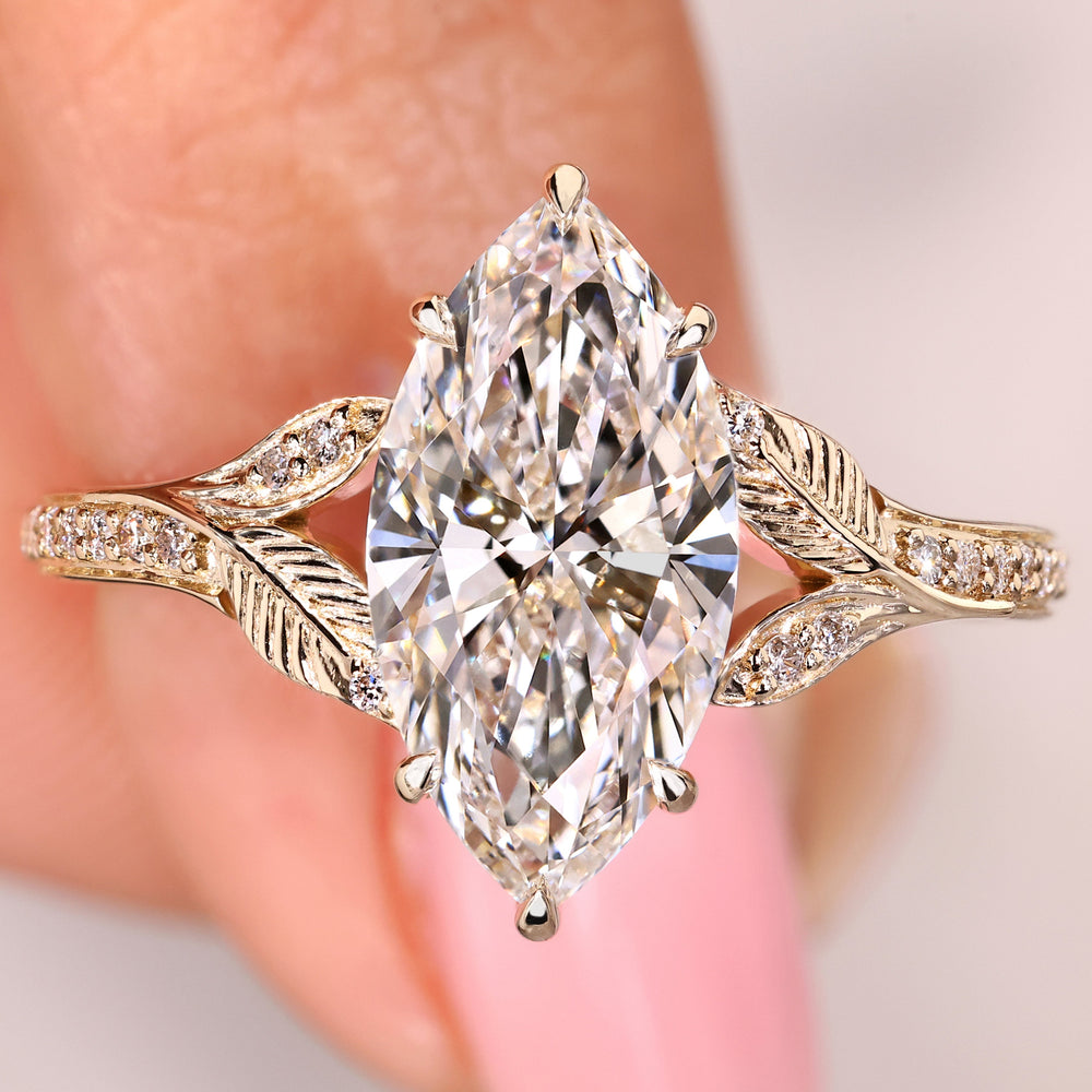 Nature inspired diamond ring with marquise center and pave band
