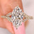 Nature inspired diamond ring with marquise center and pave band
