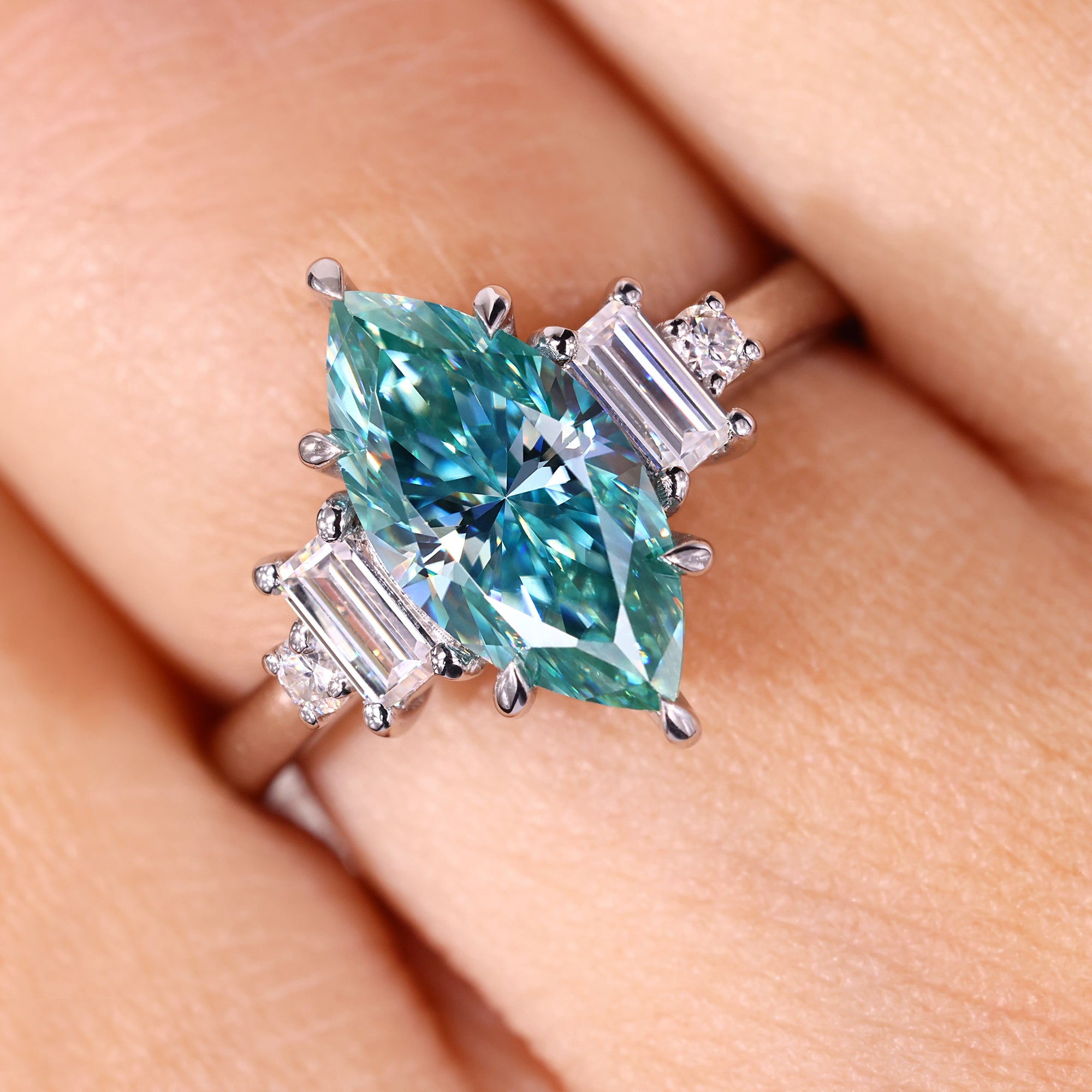 Baguette and round side stone in marquise engagement ring.