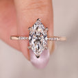 Marquise diamond engagement ring crafted with tapered shank and side diamonds.
