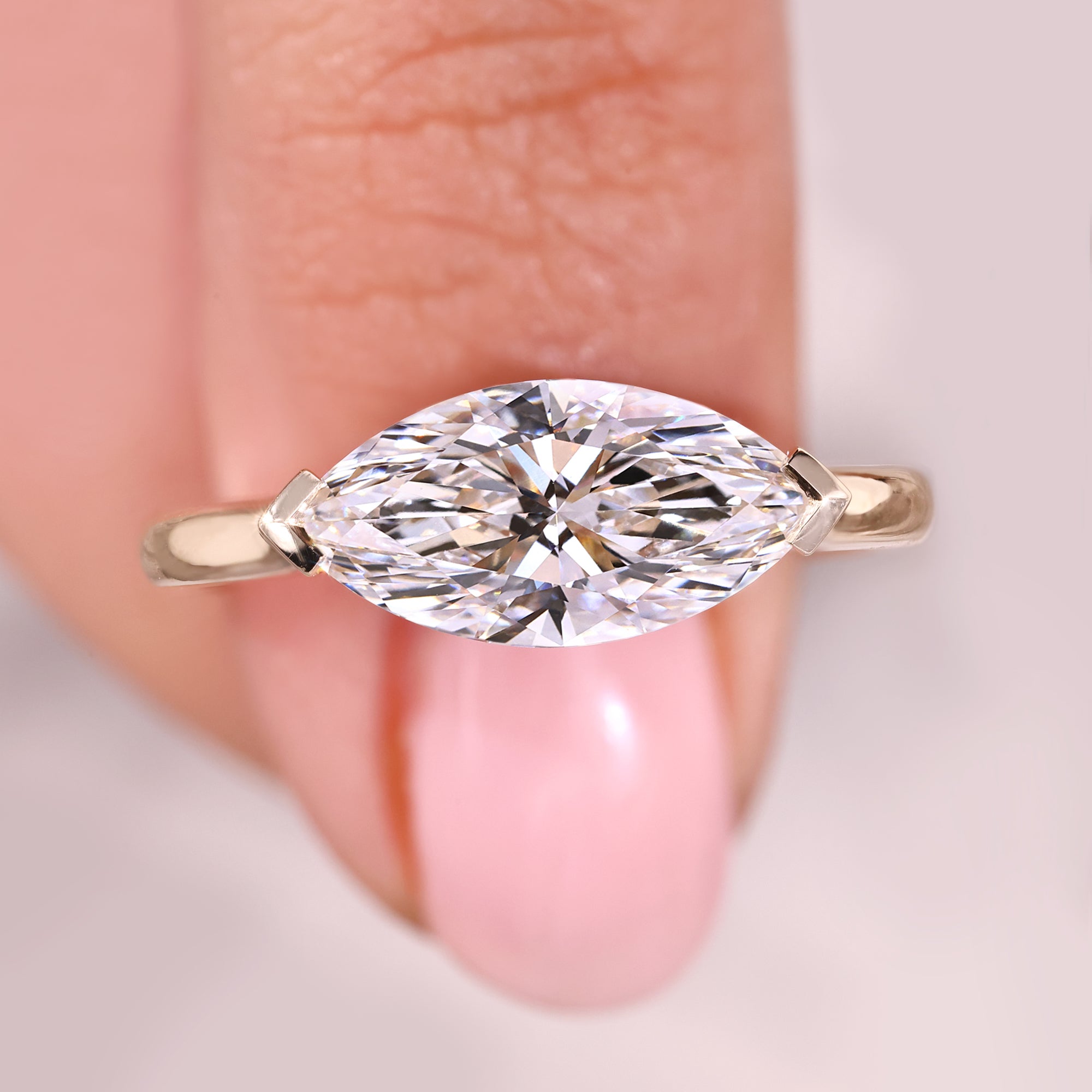Solitaire engagement ring with east to west setting ring.