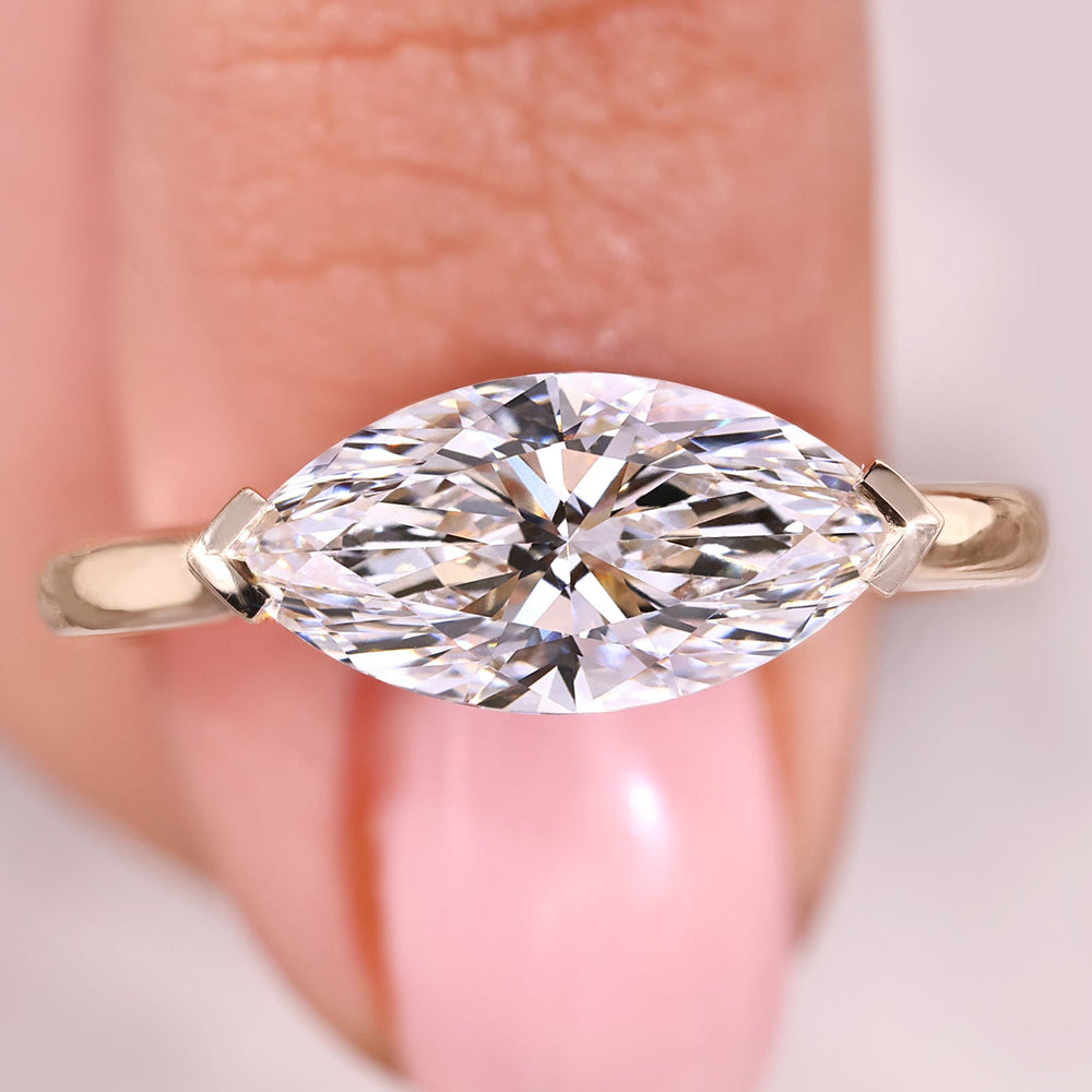 Solitaire engagement ring with east to west setting ring.