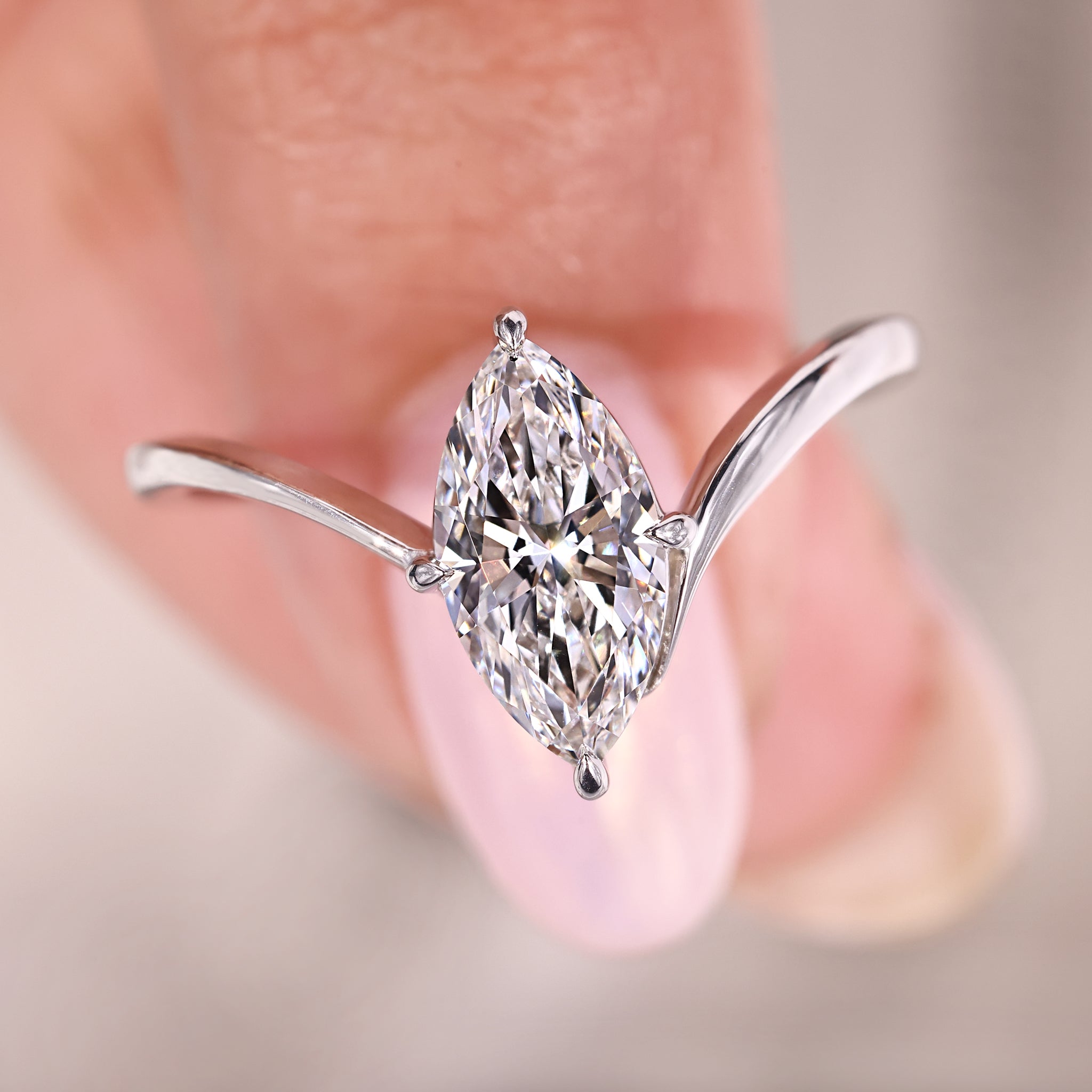 Marquise diamond ring with compass prong setting.