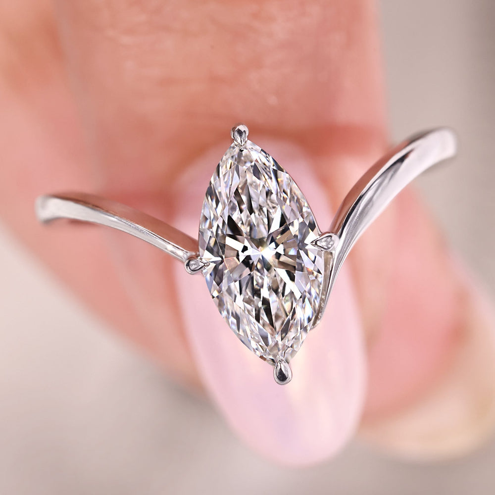 Marquise diamond ring with compass prong setting.