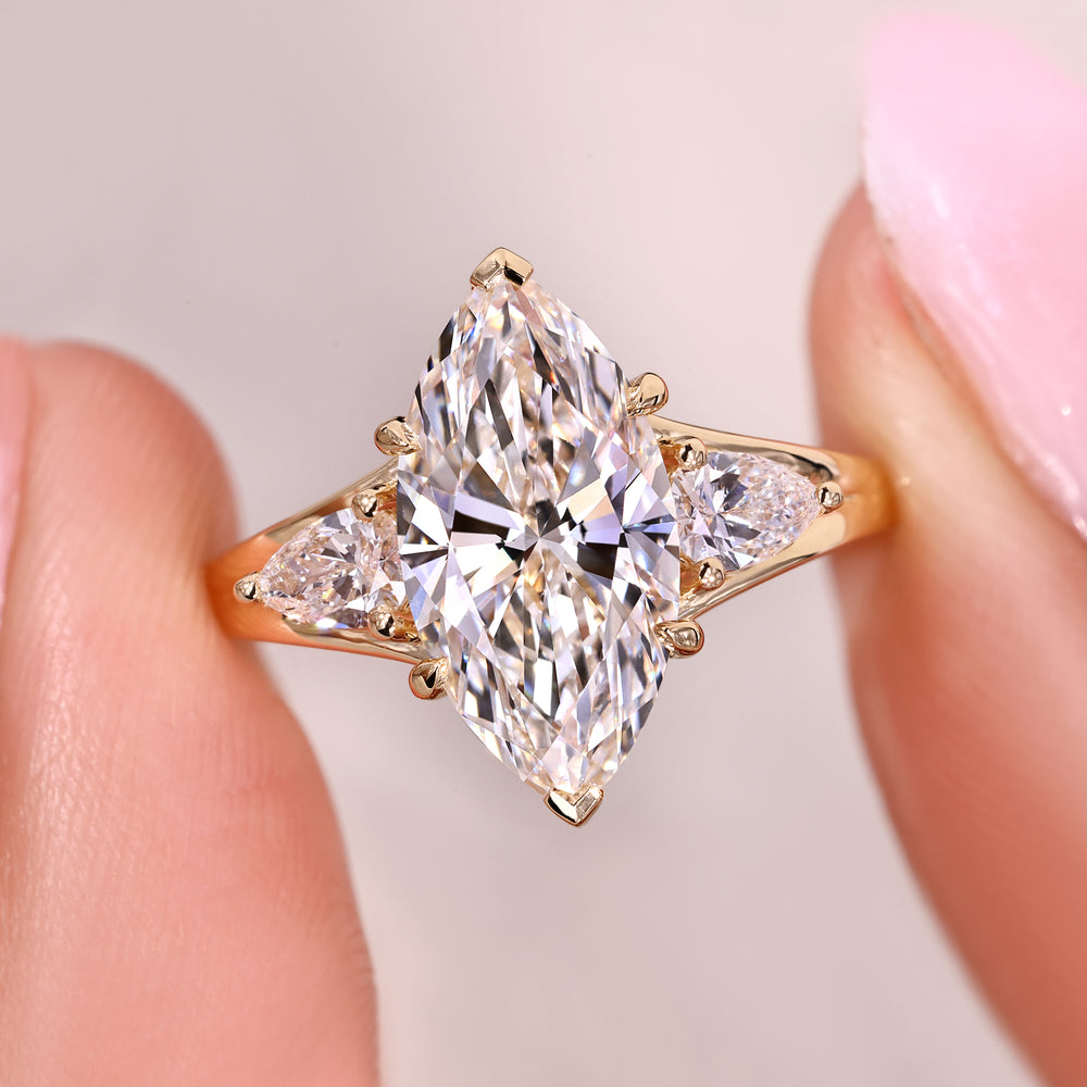 Marquise diamond ring with pear side stones.