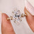 Marquise engagement ring designed with round side stones ring.