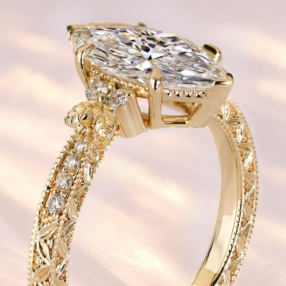 Marquise diamond ring with two V-shaped prongs.

