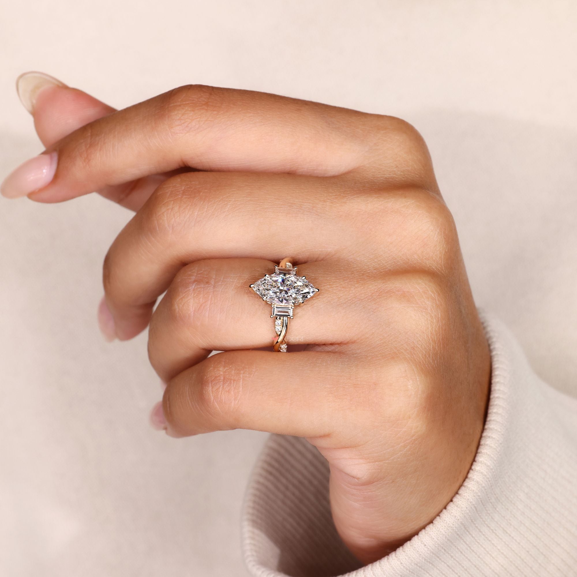Marquise diamond ring with twisted shank design.
