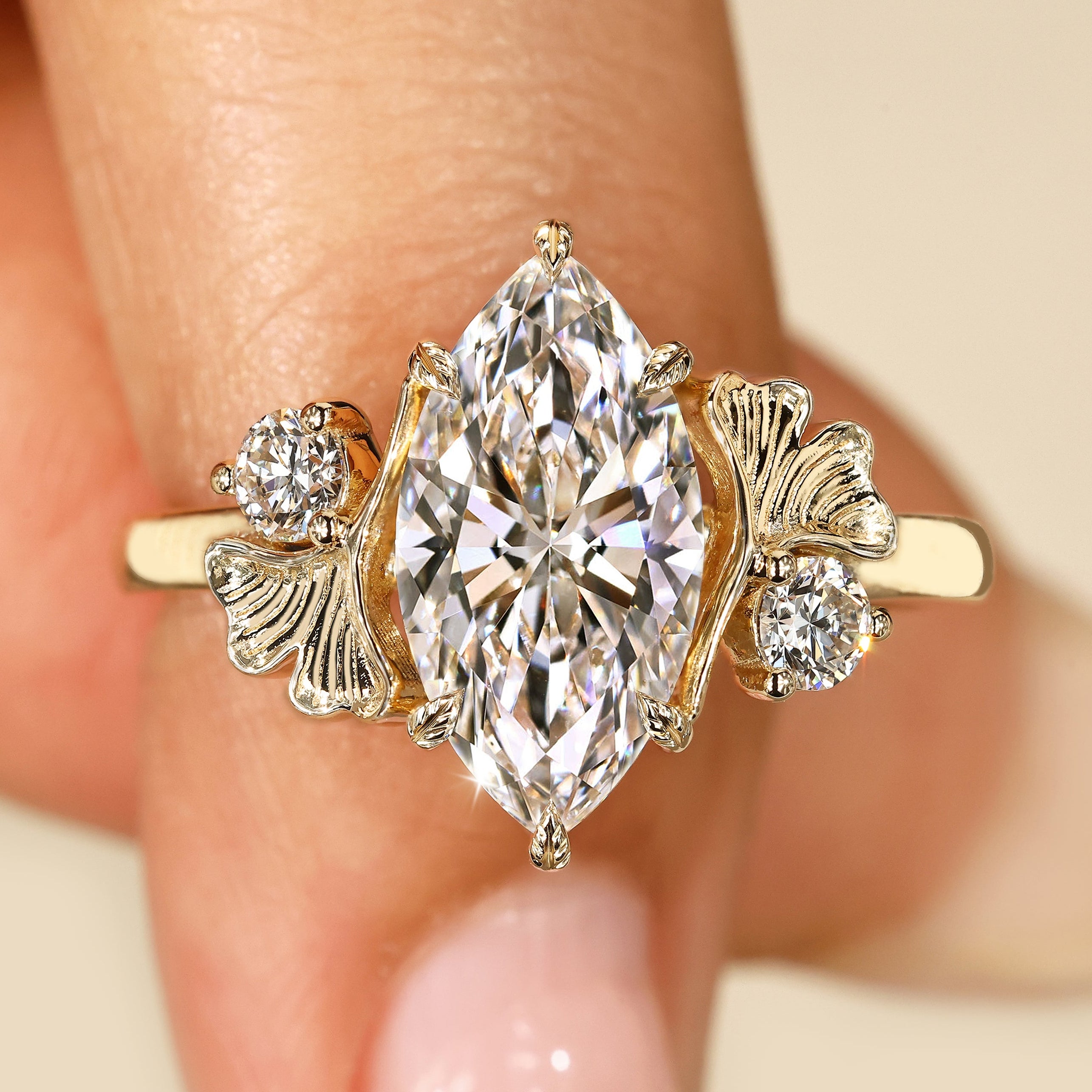 Marquise diamond ring with round side stones.
