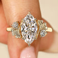 Marquise diamond ring with round side stones.
