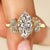 Marquise diamond ring with round side stones.
