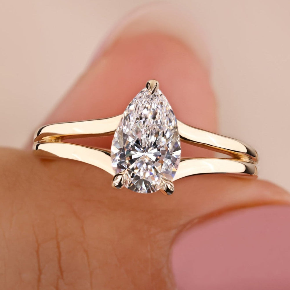Pear shaped engagement ring featuring a hidden halo setting, crafted with lab grown diamond for timeless elegance.
