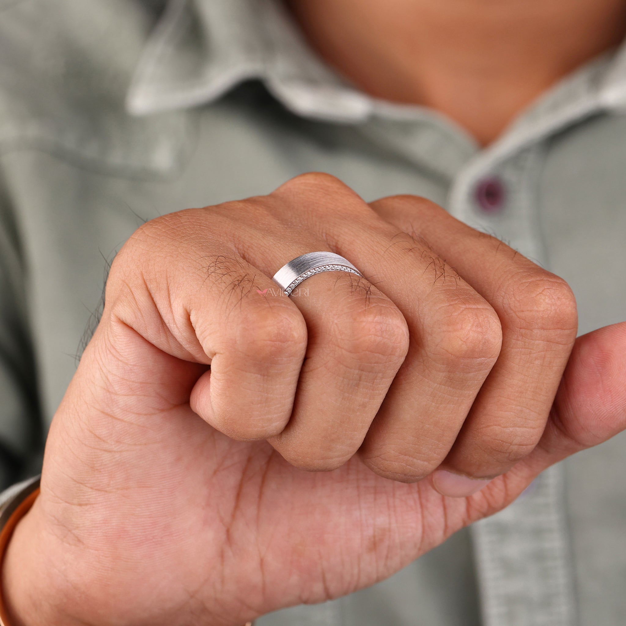 Men's eternity band with round diamonds set in a white gold wedding band.
