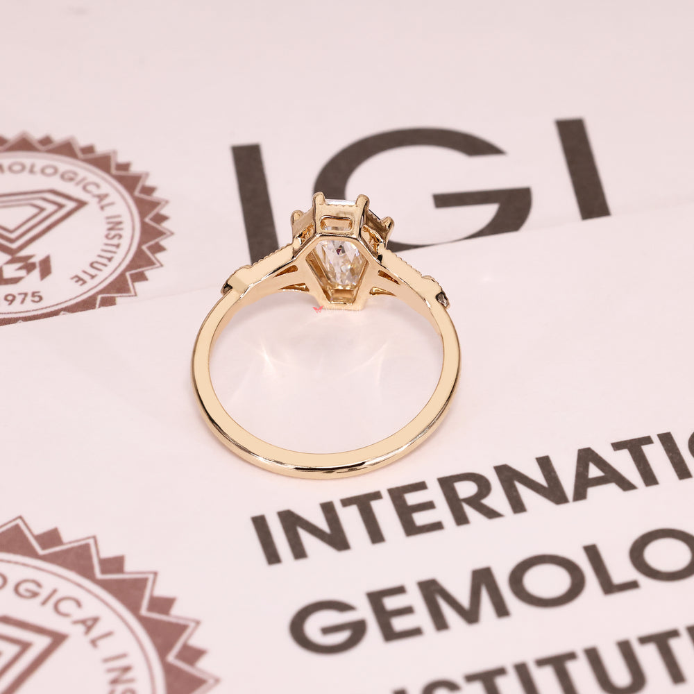 Shield cut lab diamond ring with six claw prongs.
