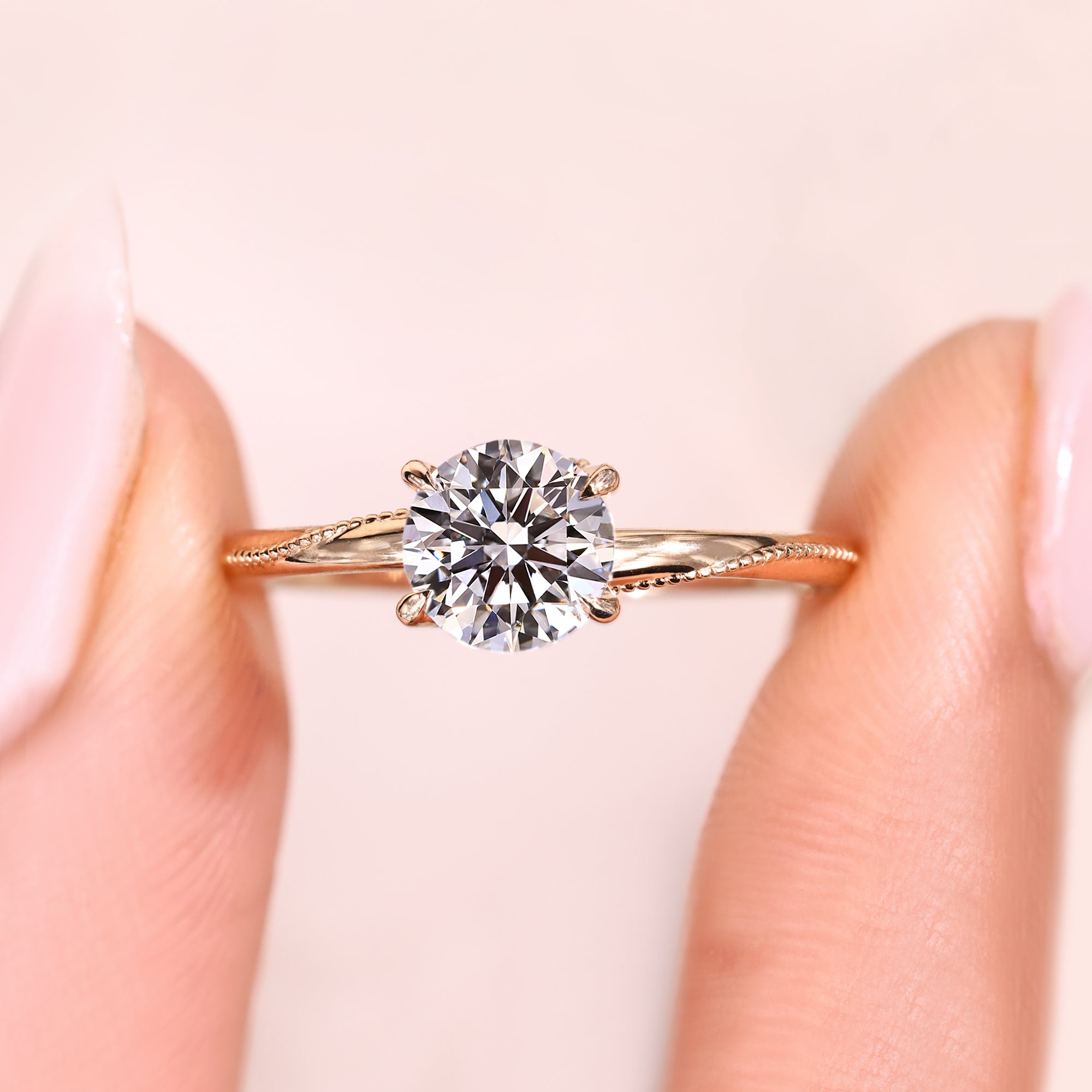 Lab grown round cut diamond ring with refined prong setting.
