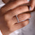 White gold eternity band featuring a continuous row of diamonds.
