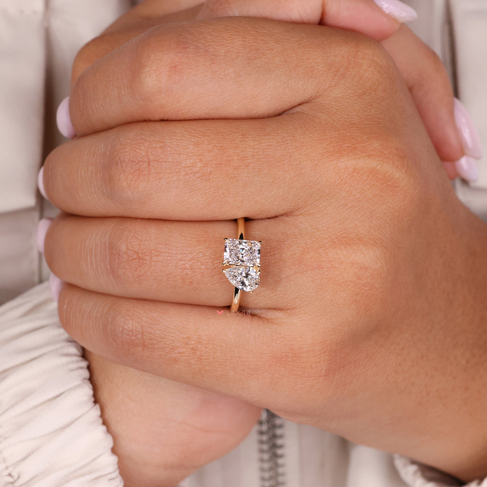 Handmade ring with a radiant cut diamond in a unique toi et moi setting.
