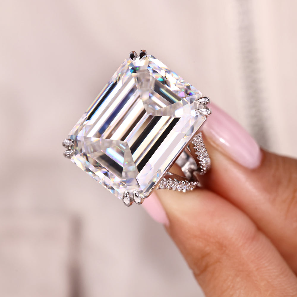 Emerald cut ring with split shank and moissanite pave.