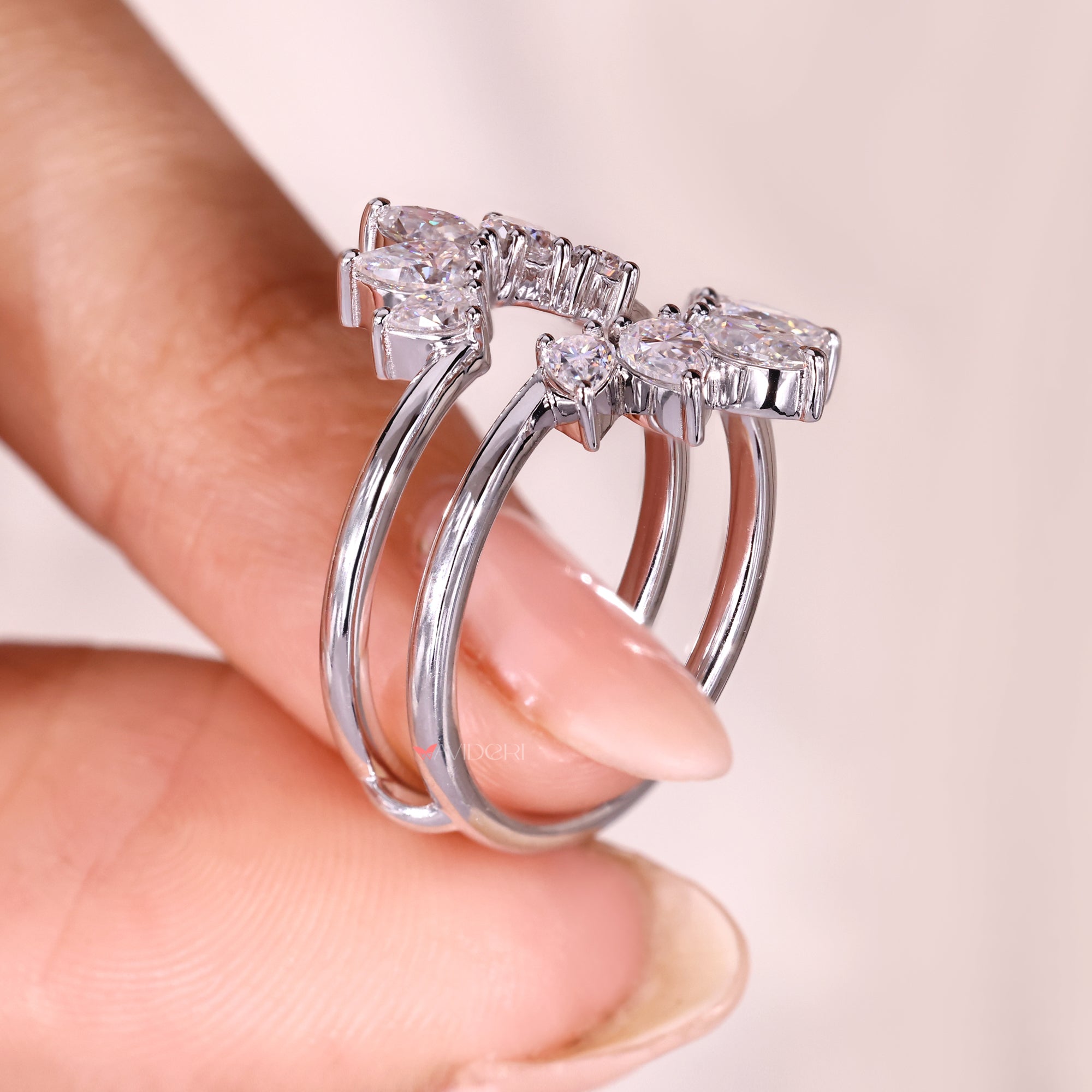 Marquise and pear cut moissanite curved enhancer band.
