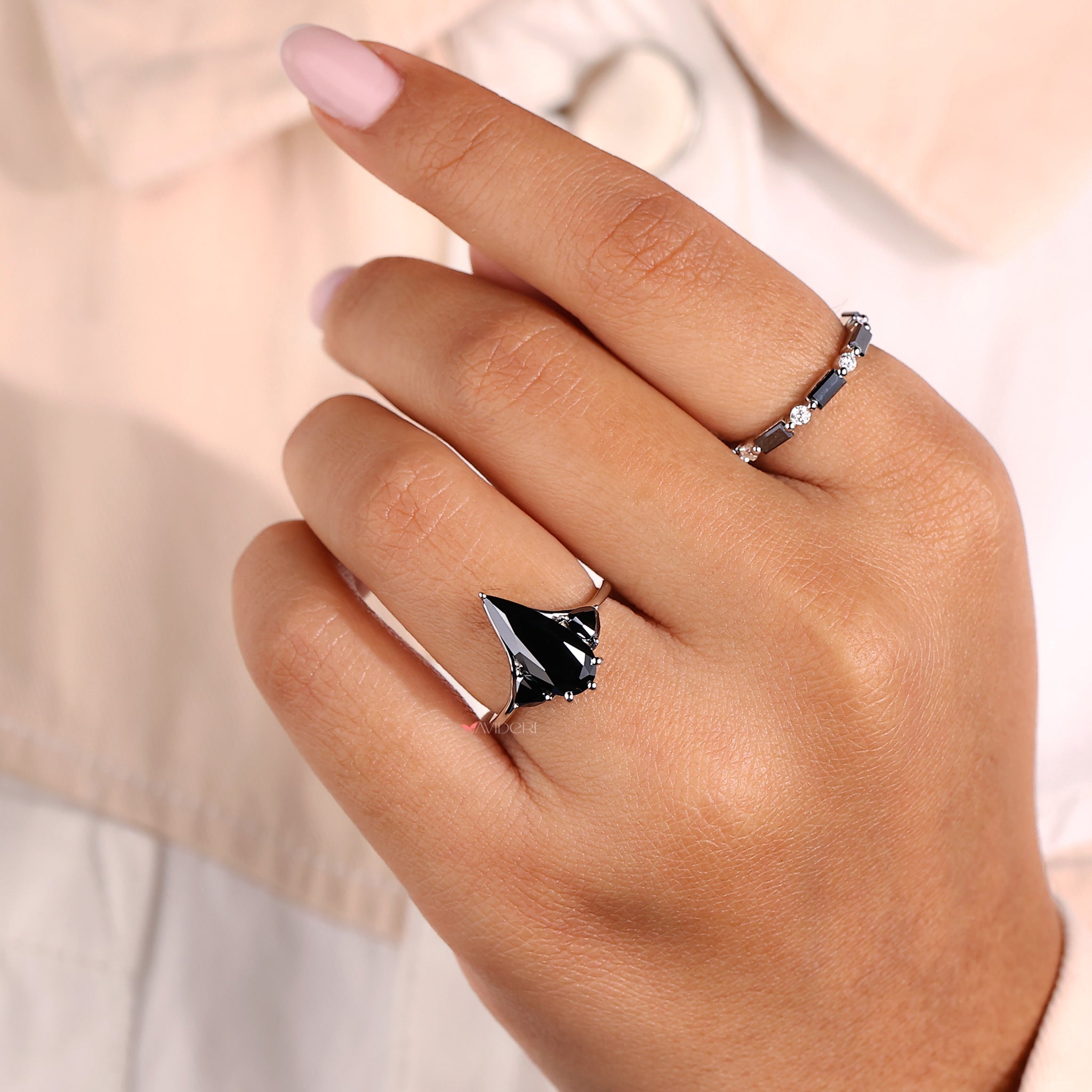 Trillion engagement ring paired with a pear-cut center stone.