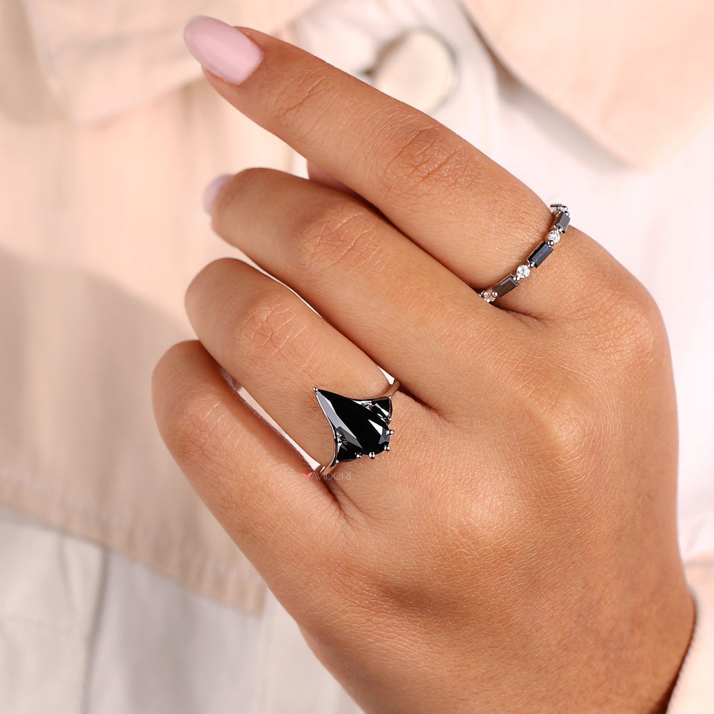 Trillion engagement ring paired with a pear-cut center stone.