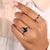 Trillion engagement ring paired with a pear-cut center stone.