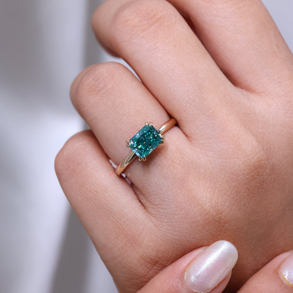 Handmade ring featuring a cyan blue moissanite center.