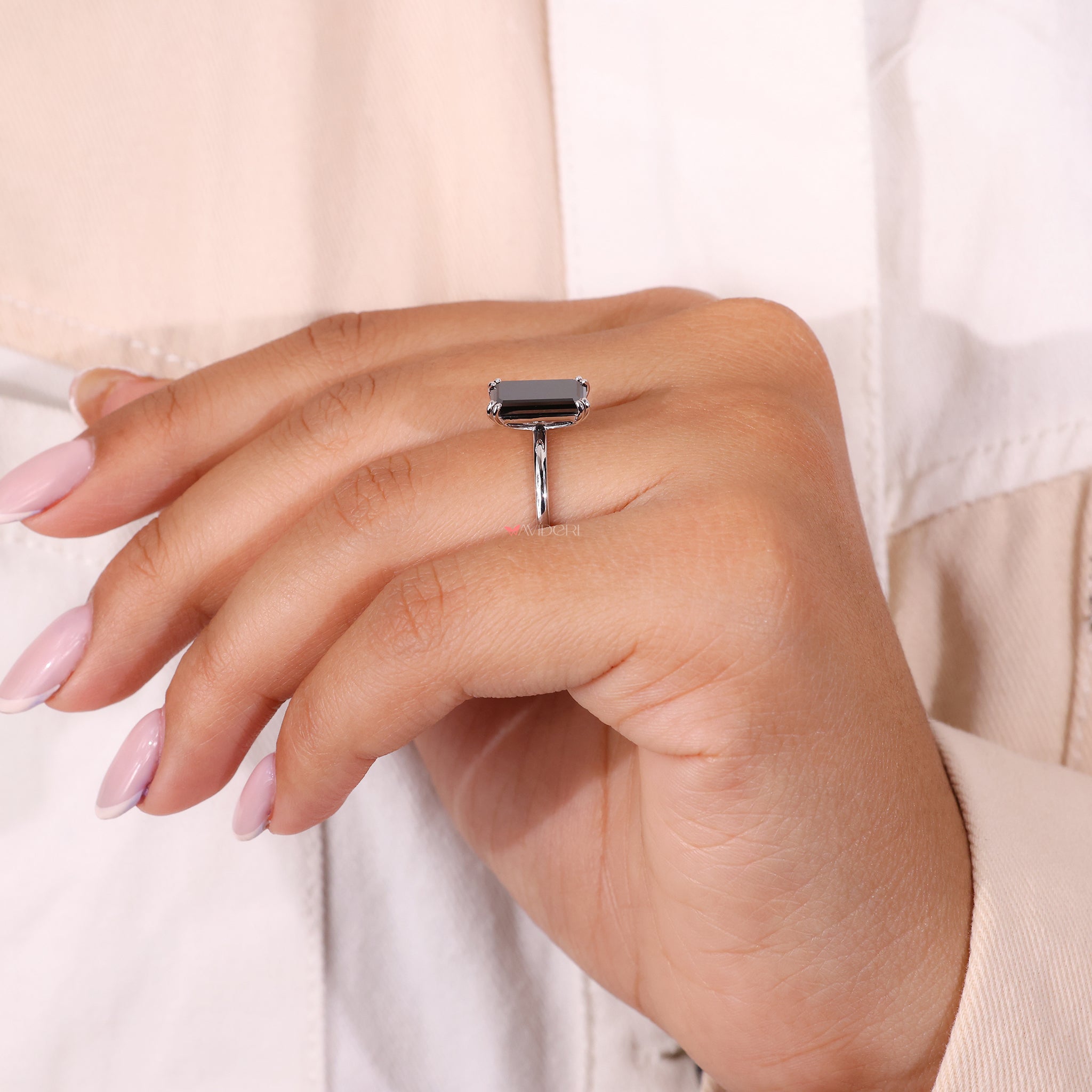 Handmade ring with an elongated emerald center stone
