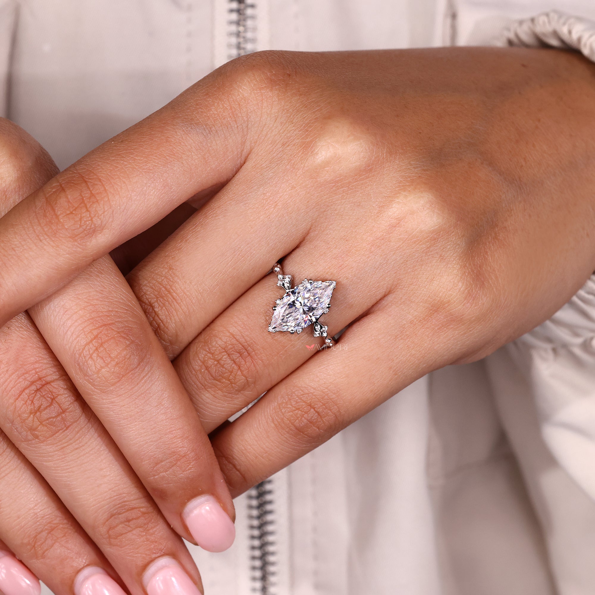 Round side stone ring designed with soft white gold shine.