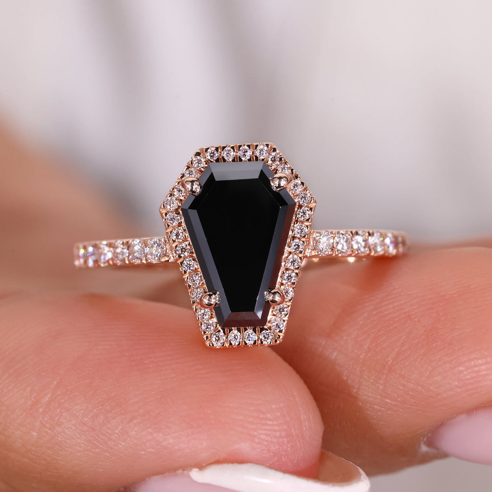 Black moissanite engagement ring with a sleek and modern design.
