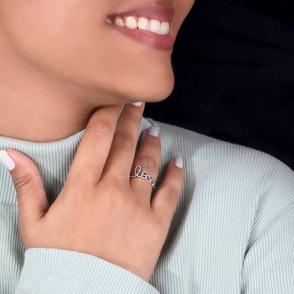 The avideri ring lies beside an open ring box.
