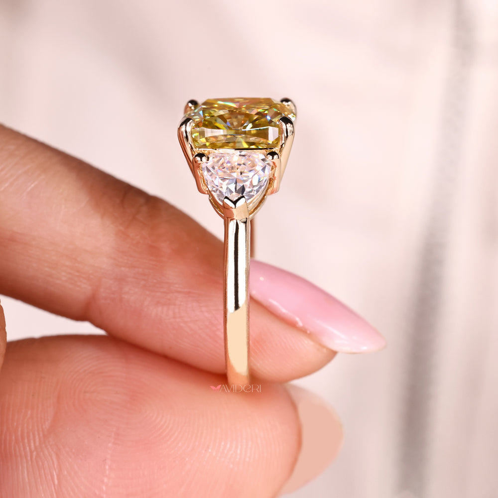 Three stone moissanite ring with cushion cut center.
