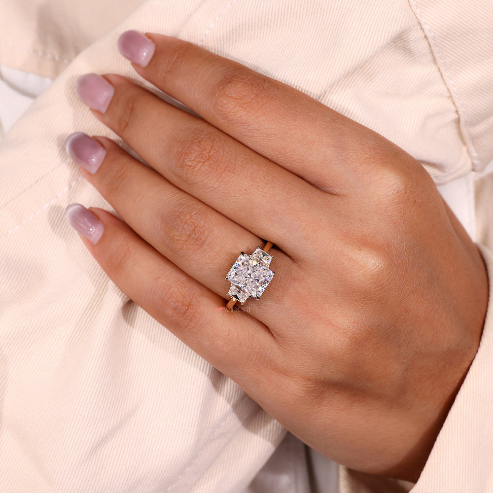 Radiant cut moissanite ring with sleek side stones.
